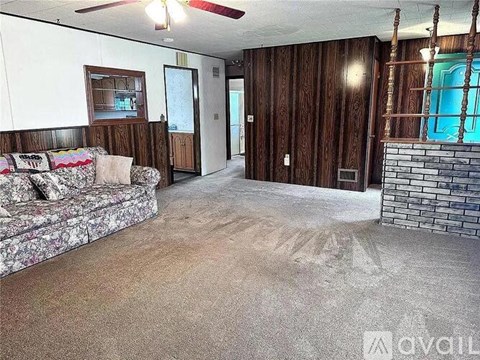 A living room with a couch and a fireplace.