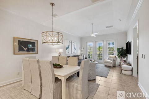 A dining room with a table and chairs.
