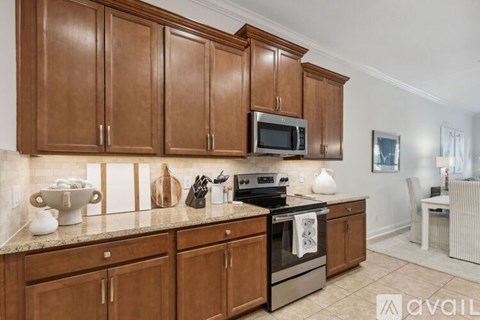 A kitchen with wooden cabinets and a granite countertop.