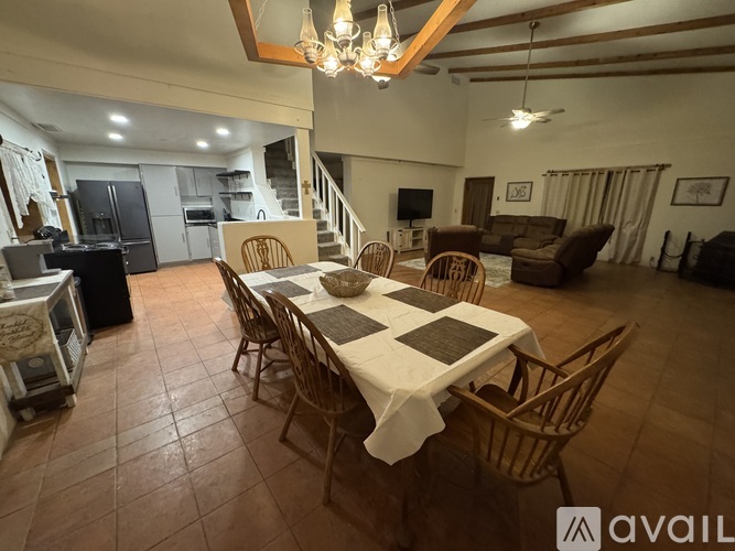 A dining room with a table set for six people.