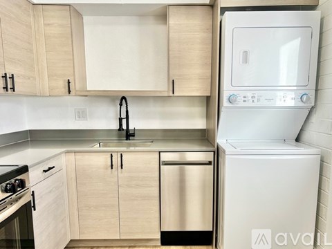 A kitchen with a white dishwasher and a white oven.