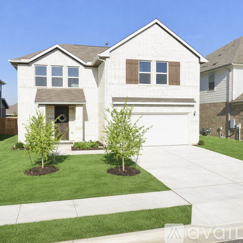 A house with a front yard and a driveway.
