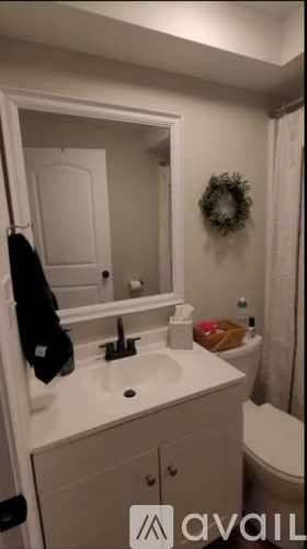 A bathroom with a white sink and a mirror.