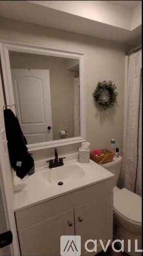 A bathroom with a white sink and a mirror.