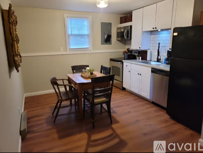 A kitchen with a table and chairs in the middle of the room.