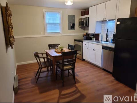 A kitchen with a table and chairs in the middle of the room.