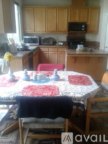 A kitchen with a table set for a meal.