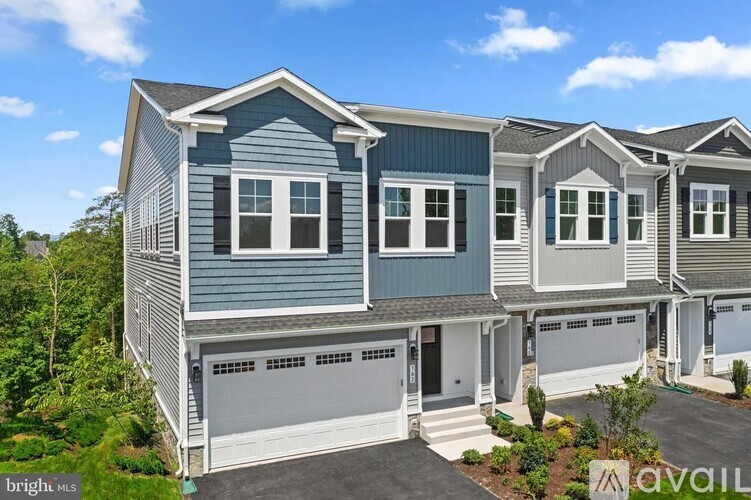 A two-story house with a garage is available for sale.