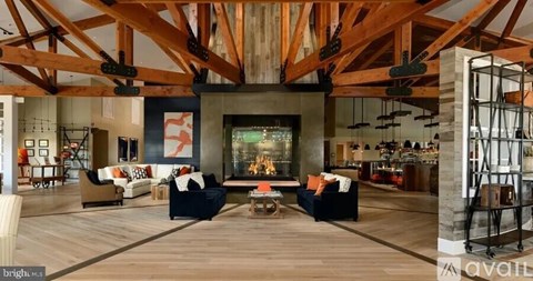 A spacious living room with a fireplace and a dining area.