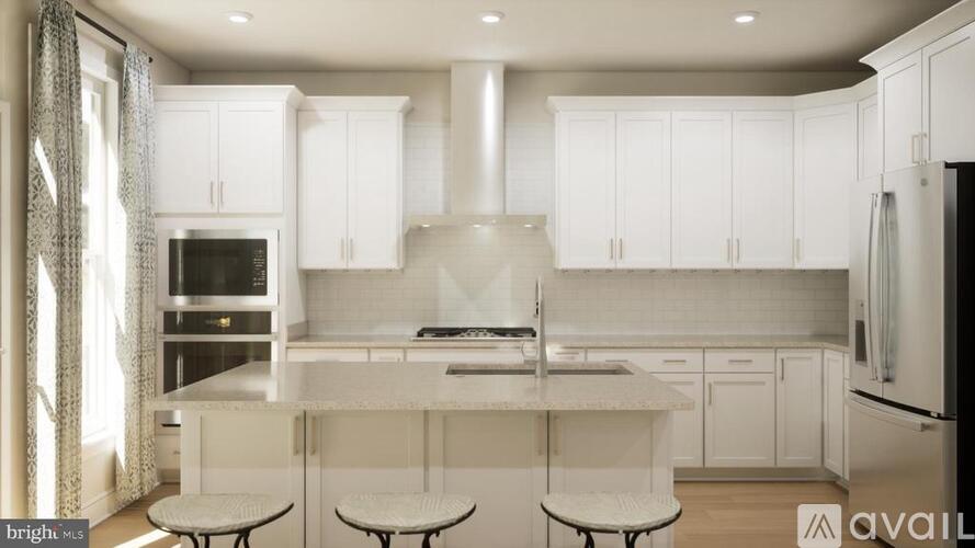 A modern kitchen with white cabinets and a central island.