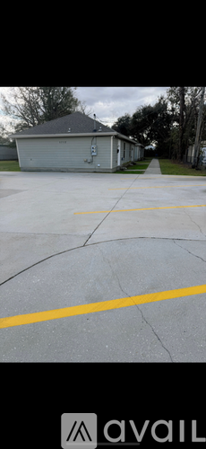 A grey house with a grey garage and a concrete driveway.