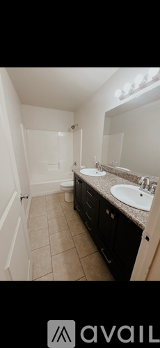 A bathroom with a sink, mirror, and toilet.