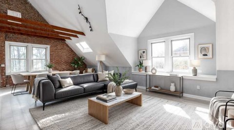 A living room with a grey sofa and a wooden coffee table.