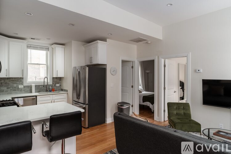 A kitchen with a black fridge and a white counter top.