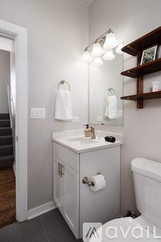 A bathroom with a white sink and a white toilet.