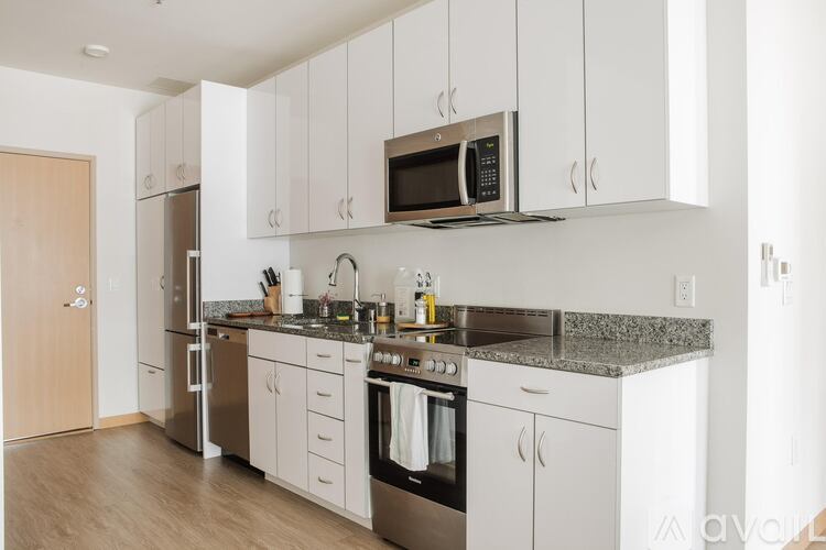 A kitchen with white cabinets and stainless steel appliances.