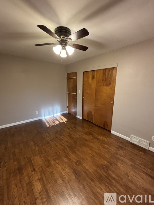 A bathroom with a toilet, a sink, and a window with blinds.