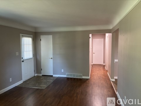 A kitchen with white cabinets and a refrigerator.