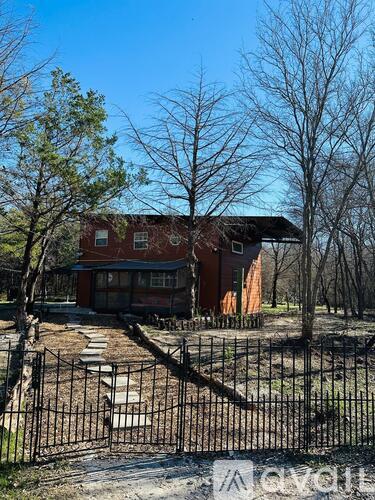 A house with a black fence in front of it.