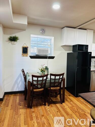 A kitchen with a table and chairs.