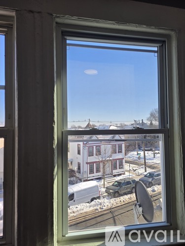 A window with a view of a residential area.