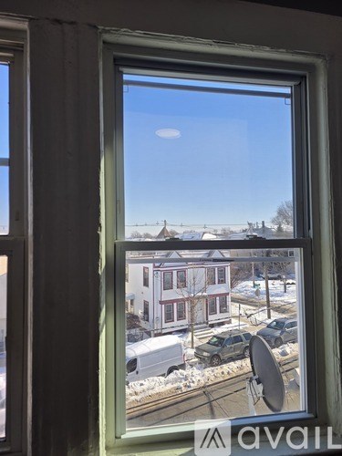 A window with a view of a residential area.