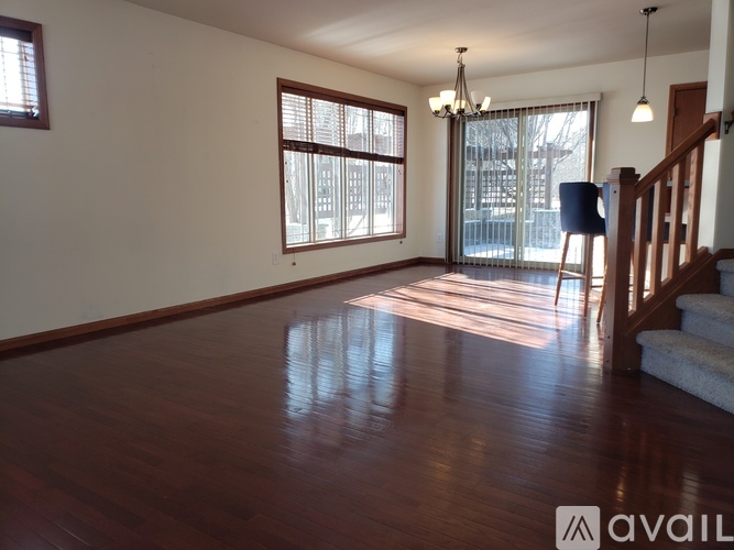 A room with wooden floors and a staircase.
