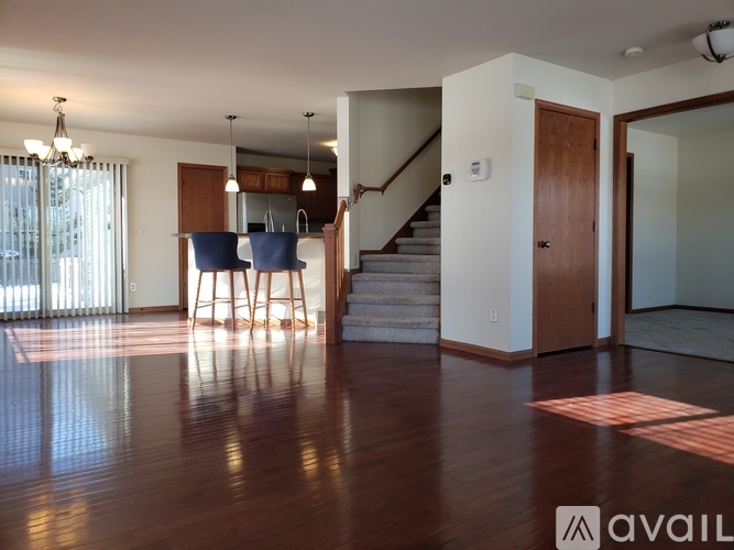 A living room with a staircase leading to the upper floor.