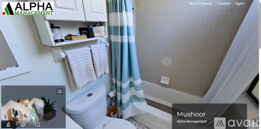 A white toilet with a white cabinet above it and a shower curtain to the right.