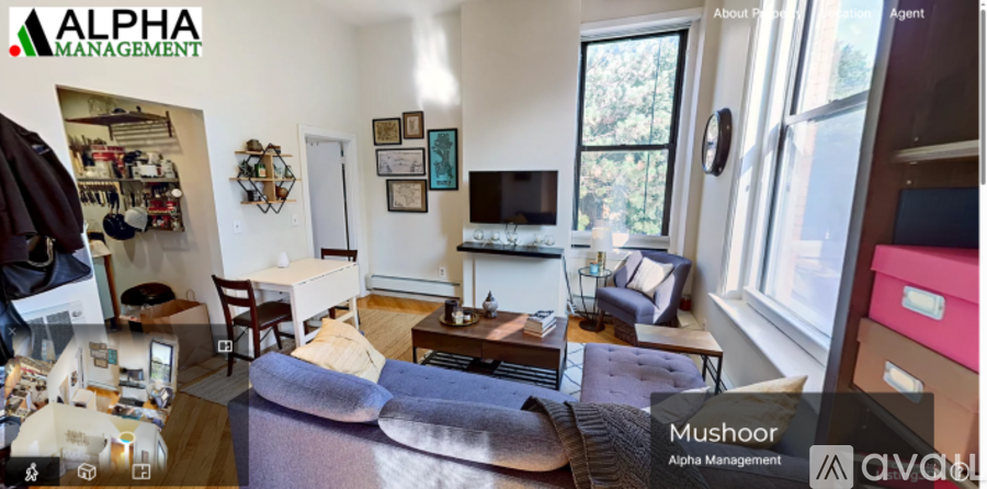 A living room with a couch, a chair, a coffee table, and a television.