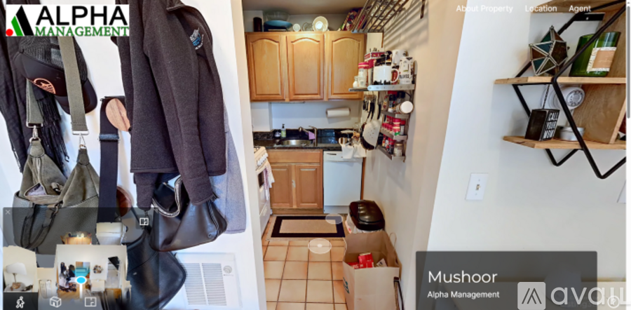 A small kitchen with a wooden cabinet and a white wall.