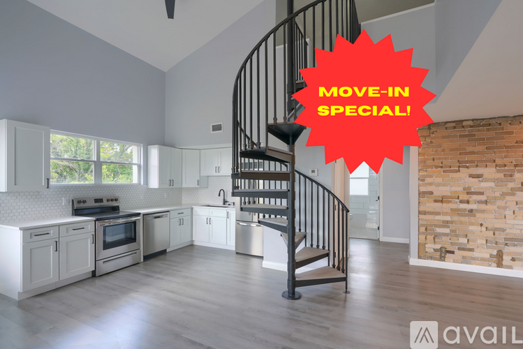 A modern kitchen with a spiral staircase and a sign that says "Move-in Special!".