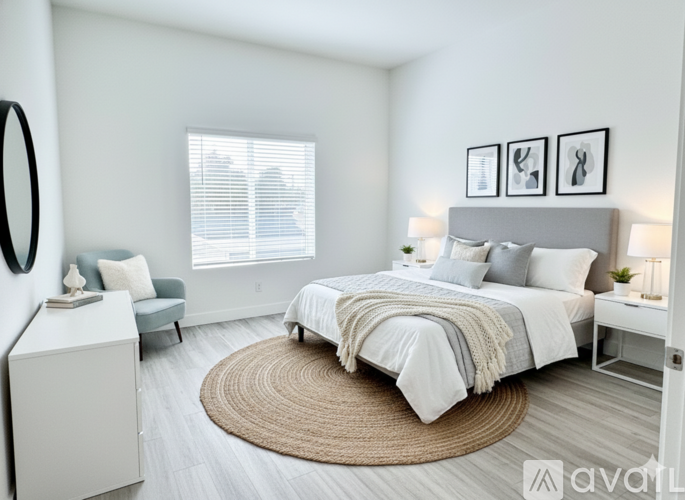 A bedroom with a large bed and a grey headboard.