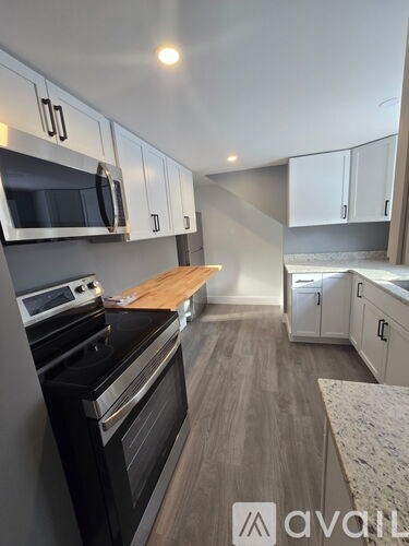 A kitchen with a stove top oven and microwave above it.