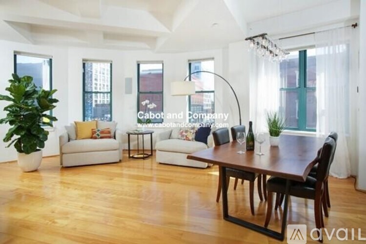 A living room with a wooden floor and white walls.