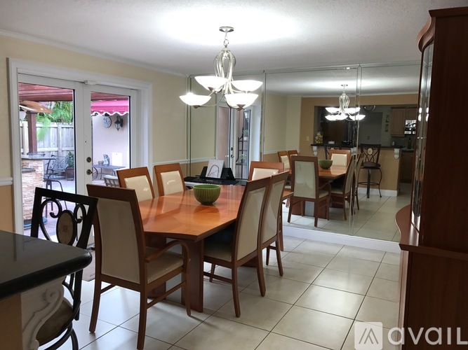 A dining room with a table and chairs.