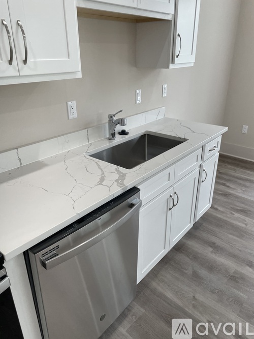 A kitchen with a sink and a dishwasher.