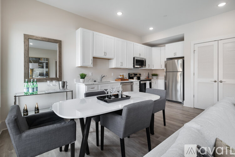 A modern kitchen with a dining table and chairs.
