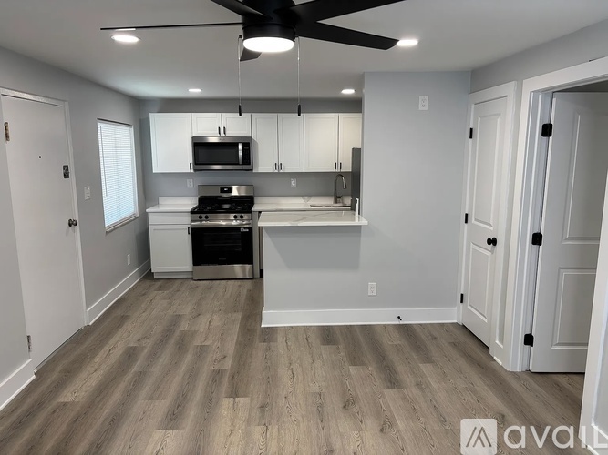 A kitchen with white cabinets and stainless steel appliances.