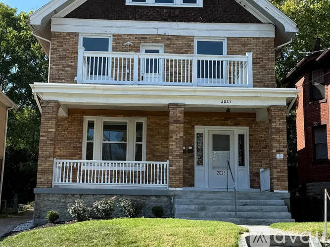 A brick house with a white door and windows.