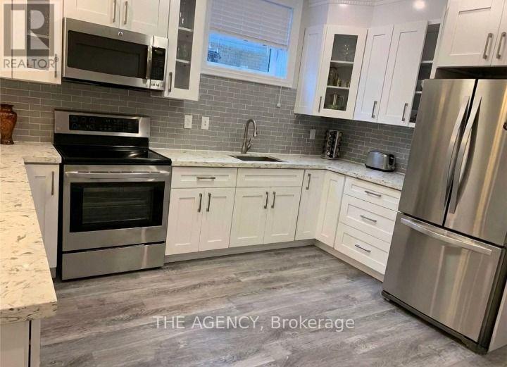 A kitchen with white cabinets and stainless steel appliances.