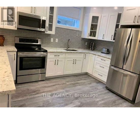 A kitchen with white cabinets and stainless steel appliances.