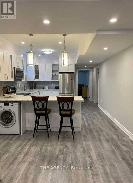 A modern kitchen with a dining table and chairs.