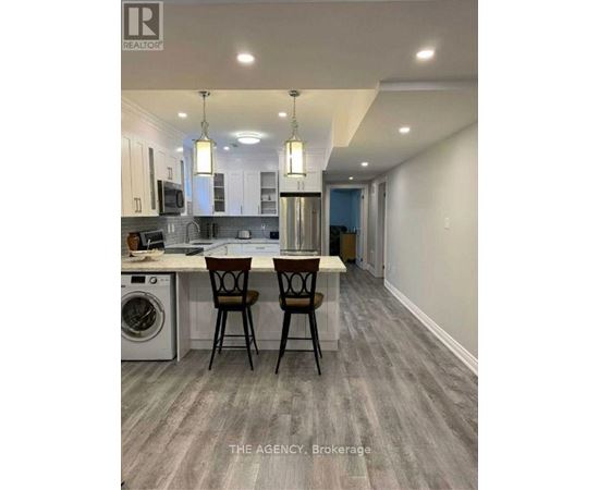 A modern kitchen with a dining table and chairs.