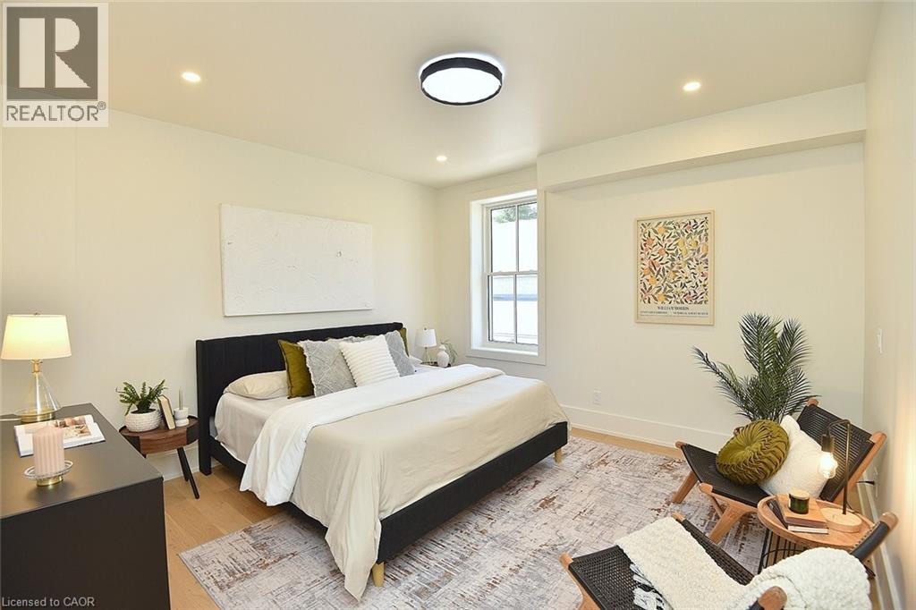 A bedroom with a large bed and a rug on the floor.