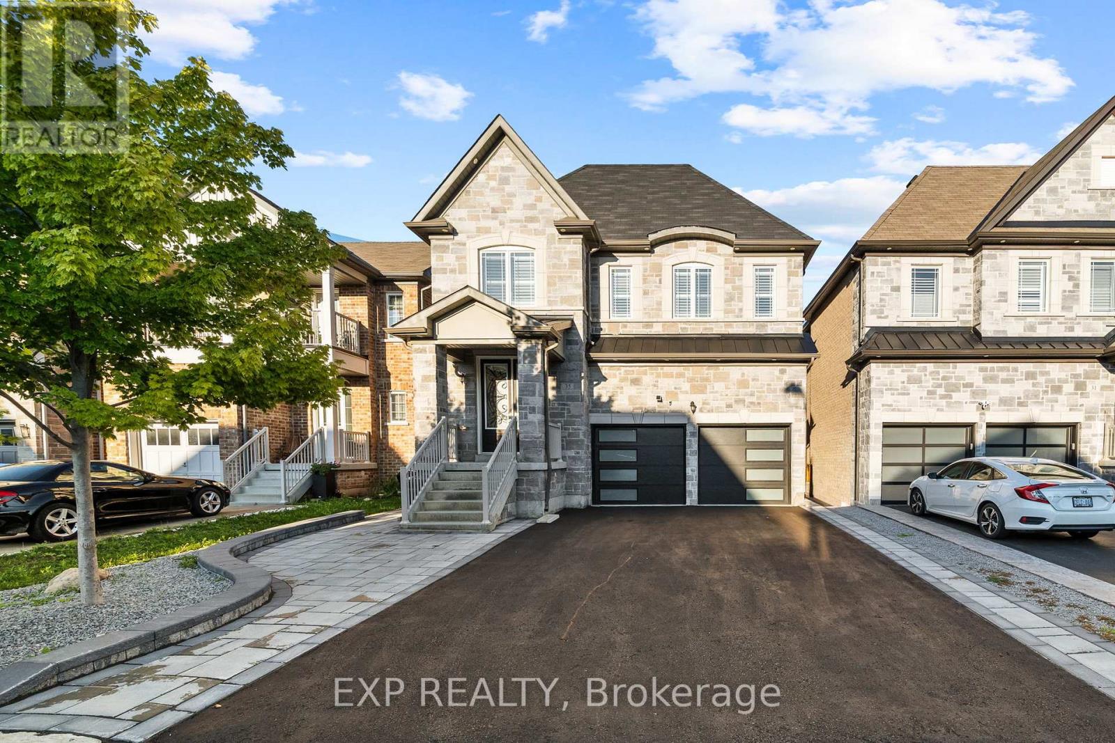 A house with a driveway and a car parked in front.