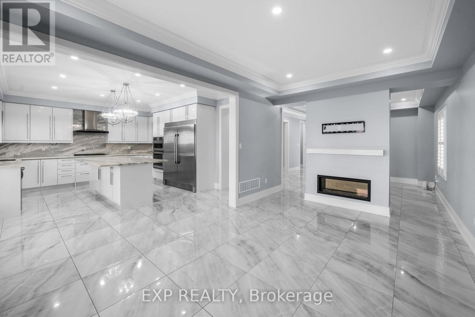 A modern kitchen with a marble floor and a fireplace.