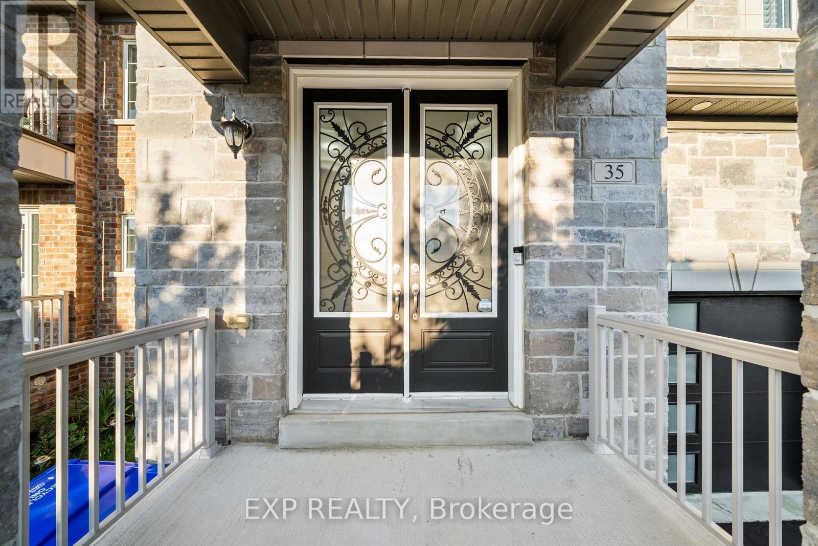 A black door with a glass window and a metal design on it.