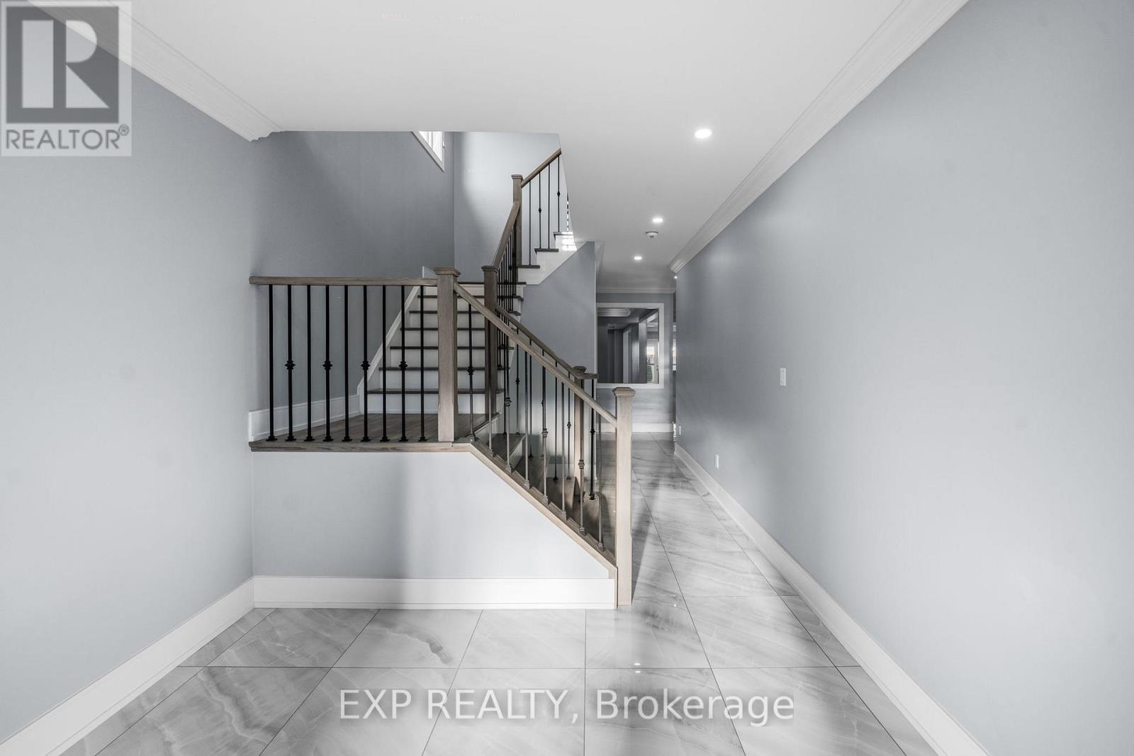 A spacious hallway with a staircase leading to the upper level.