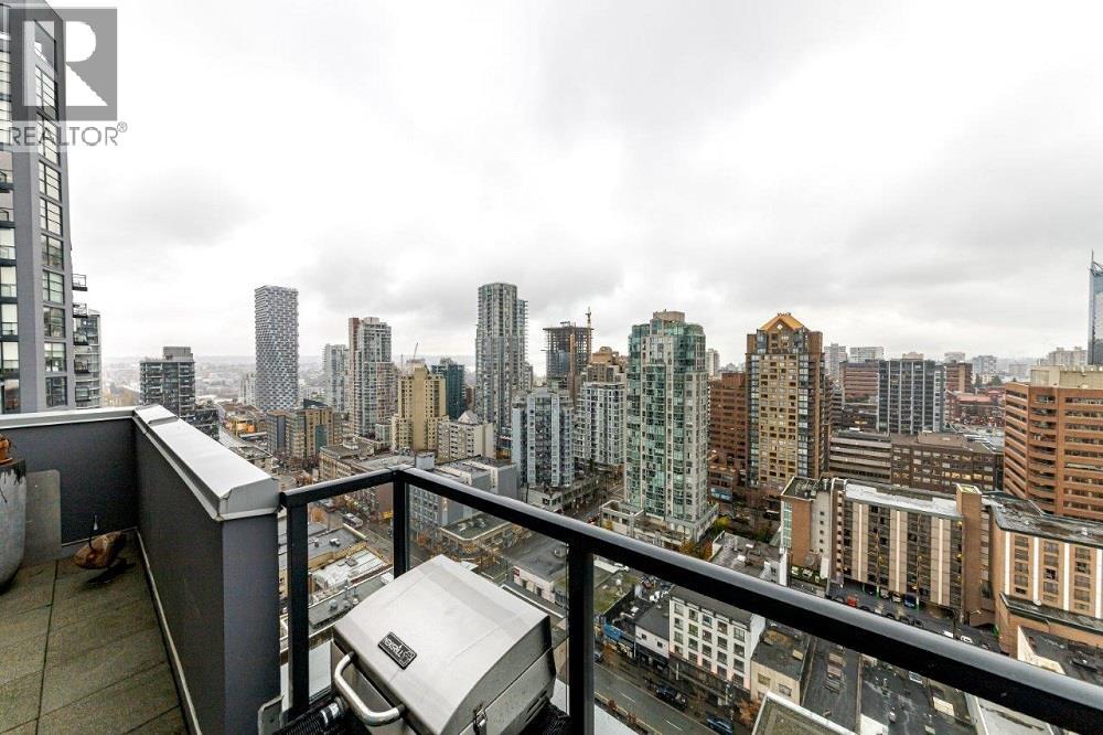 A cityscape with a cloudy sky and buildings of various heights.